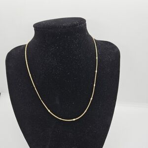 delicate gold tone chain necklace with flat stations